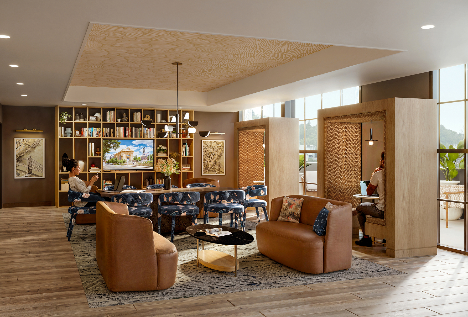 Resident lounge at Albion Lawrenceville apartments in Pittsburgh, PA, featuring a long table and wood grain flooring.