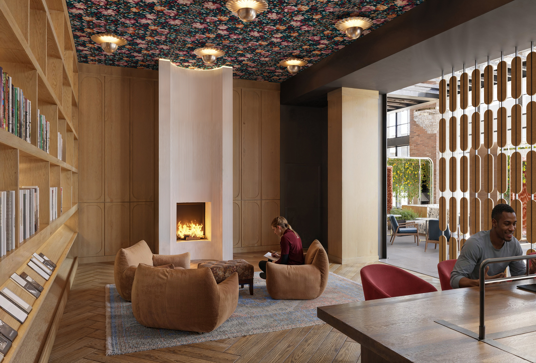 Resident lounge at Albion Lawrenceville apartments in Pittsburgh, PA, featuring cushioned seating and wood grain flooring.
