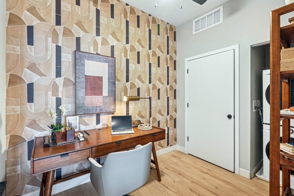 Desk with chair and patterned wallpaper